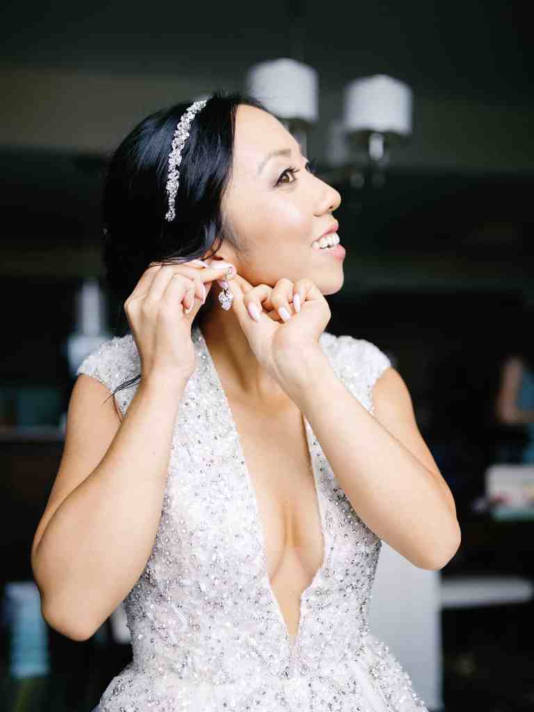 Bride putting in her earrings