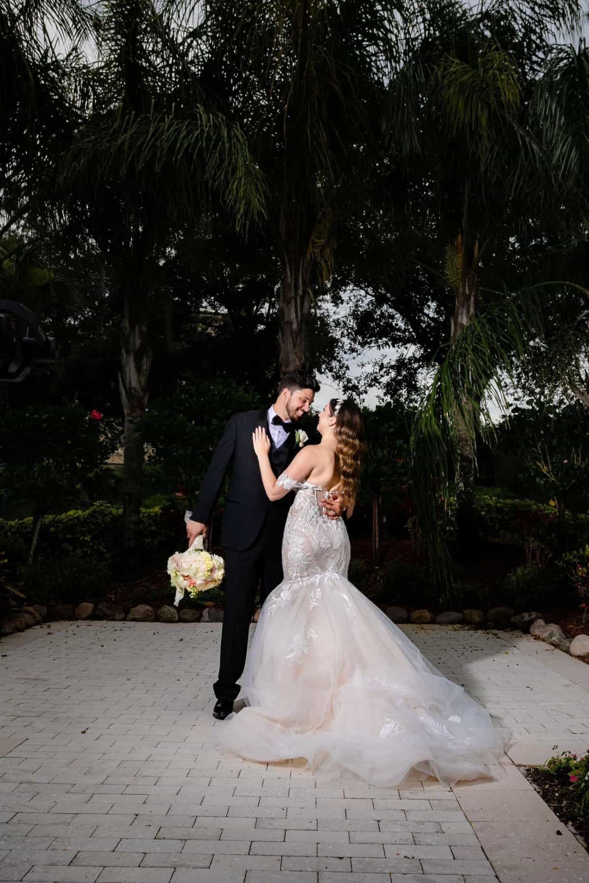 Bride and groom standing outside