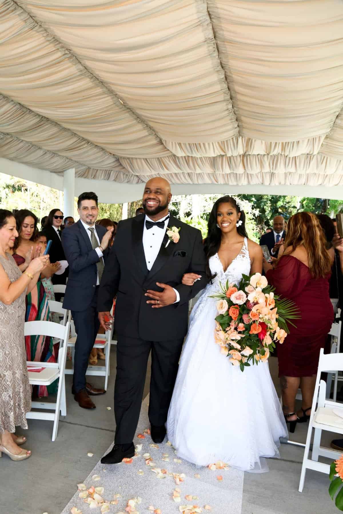 Bride being escorted up the aisle