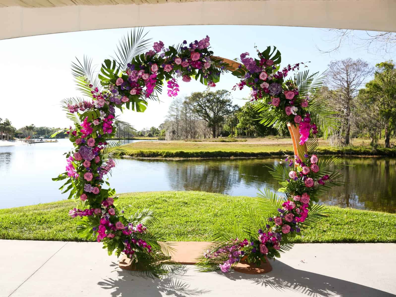 Wedding ceremony decor; circular arch with pink and purple tropical floral