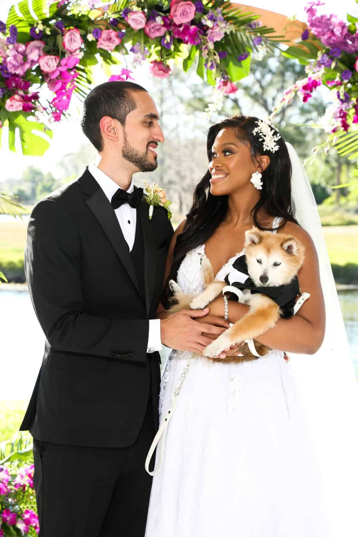 Bride and groom posing with their dog
