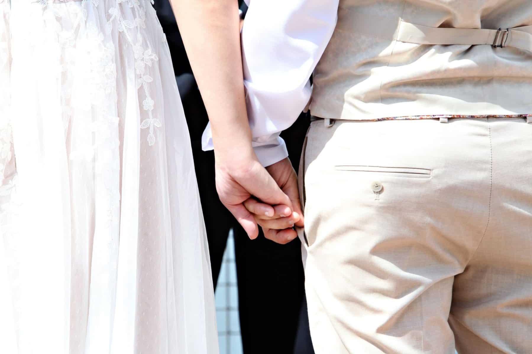 Bride and groom holding hands