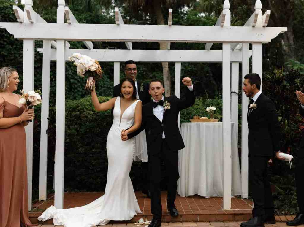 Bride and groom celebrating after being introduced as husband and wife