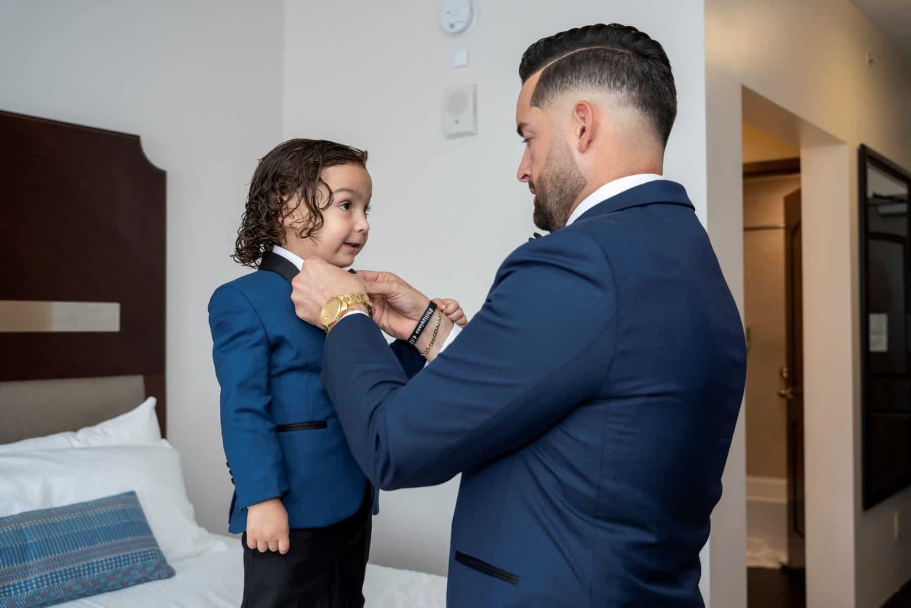 Getting ready moments between groom and son