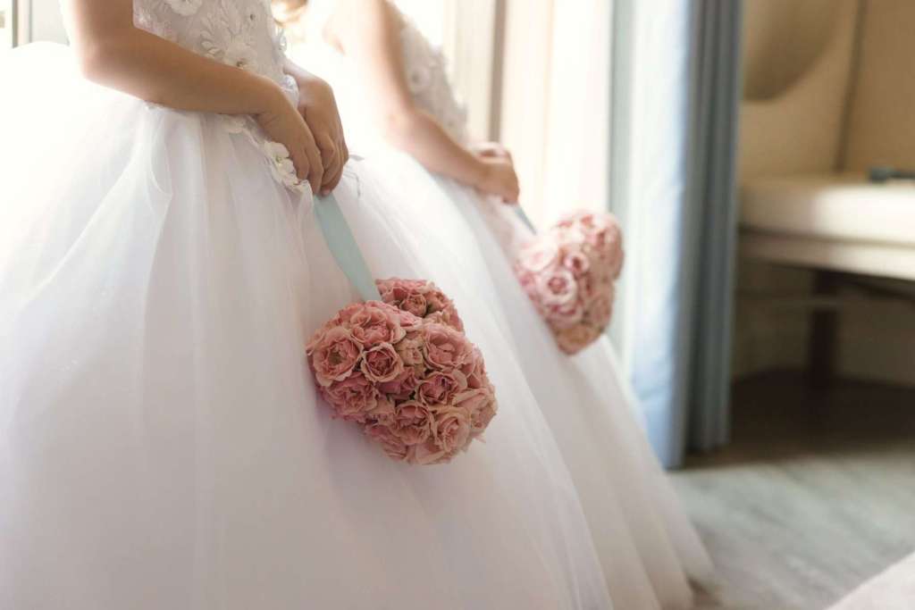 Flower girls holding pink Mickey pomanders