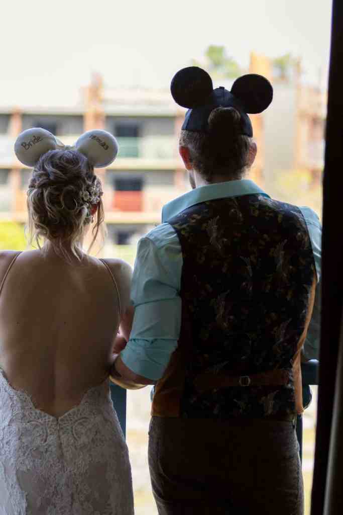 Bride and groom portraits with Mickey and Minnie ears at Paradise Cove in Disney Springs Orlando