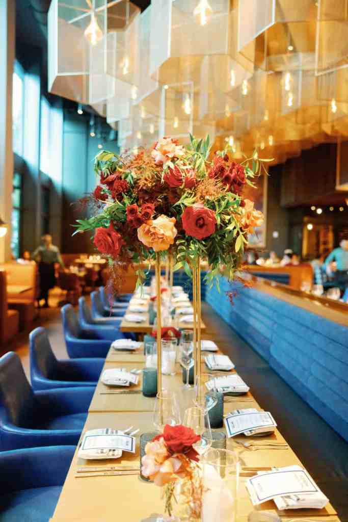 Red and pink rose centerpiece on gold stand