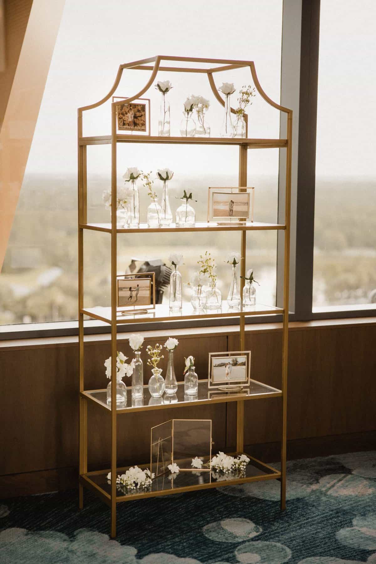 White and gold wedding reception photo display