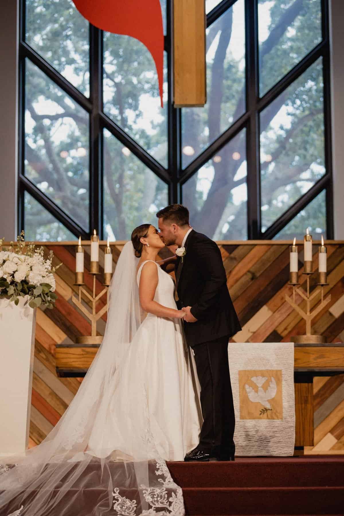 Bride and groom sharing their first kiss as husband and wife