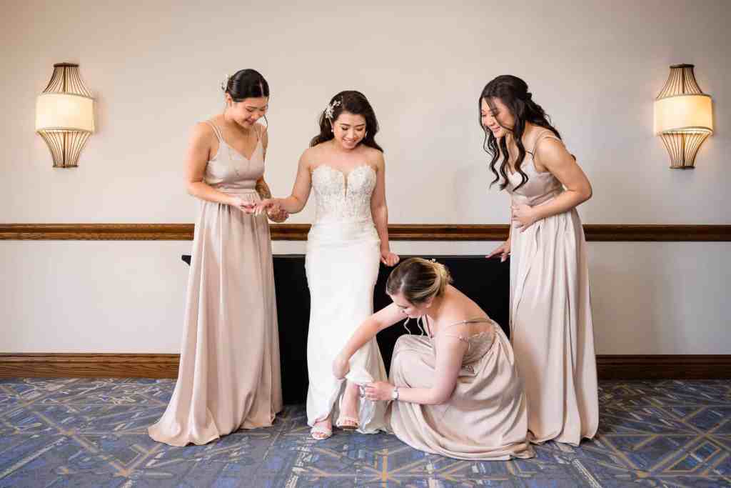 Bridesmaids helping the bride get ready