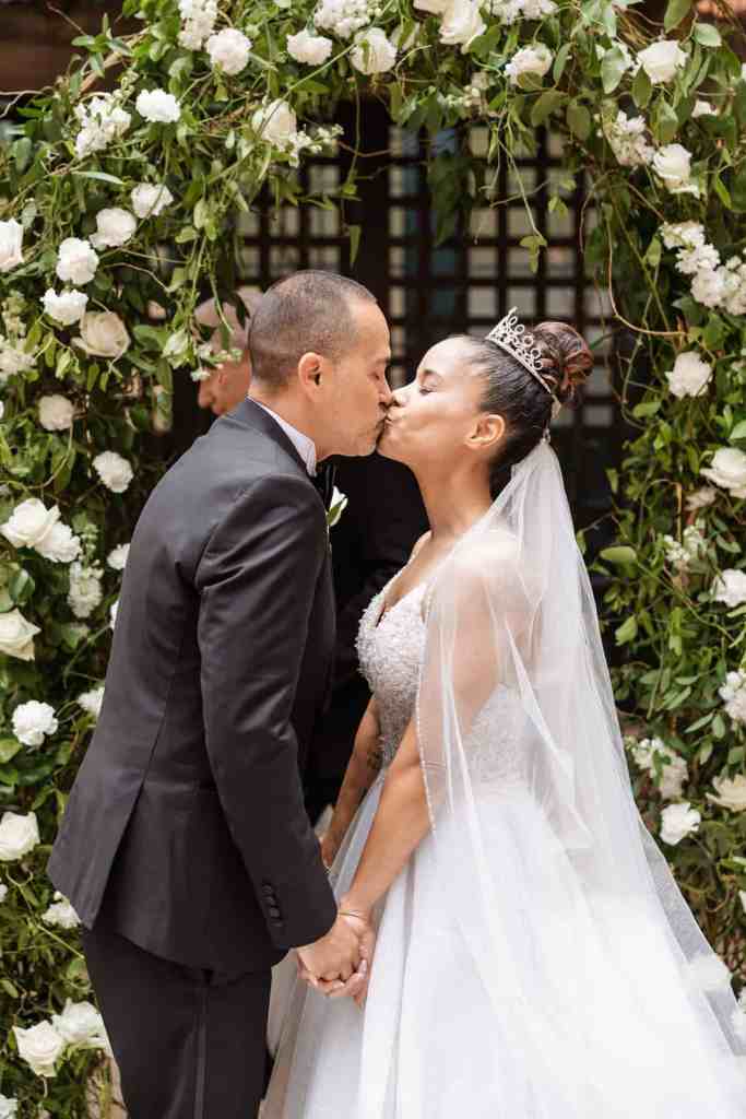 Bride and groom sharing their first kiss
