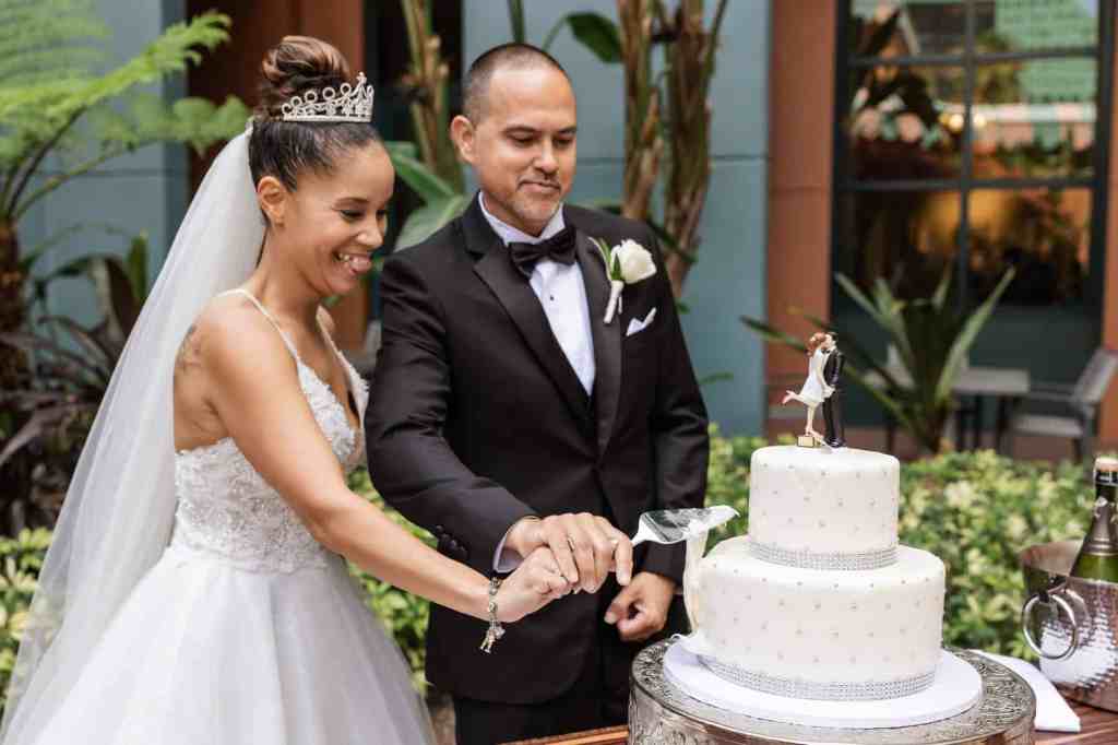 Bride and groom cutting their wedding cake