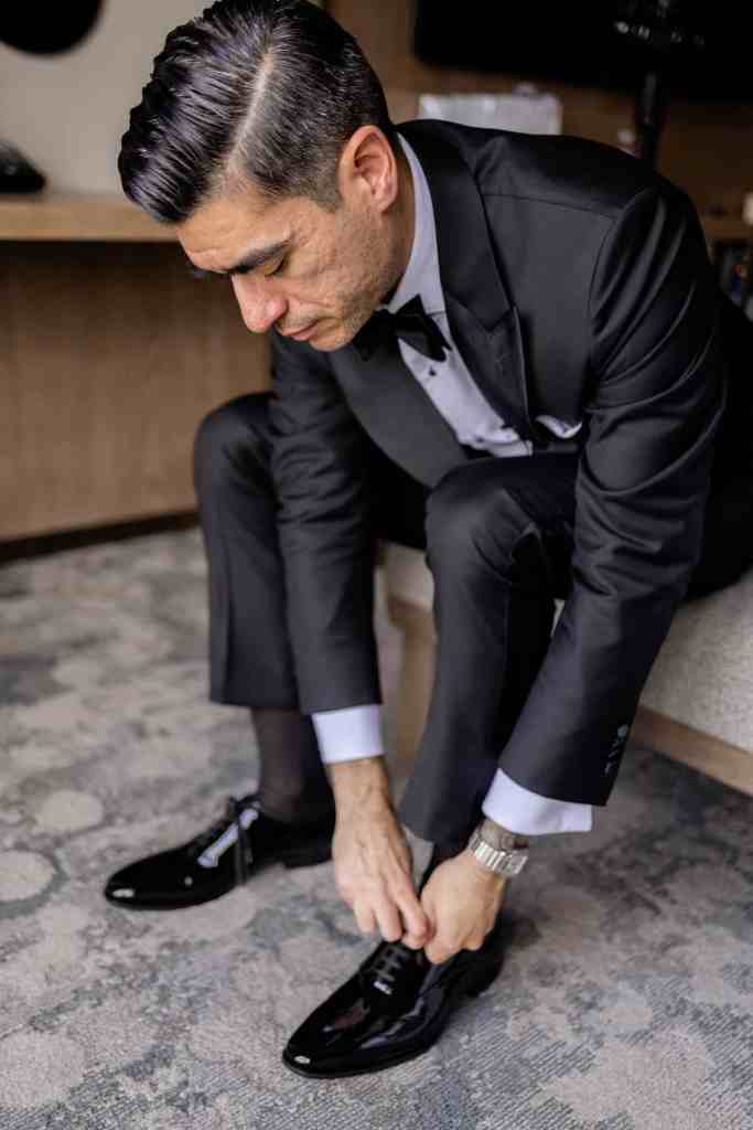 Groom tying his shoes