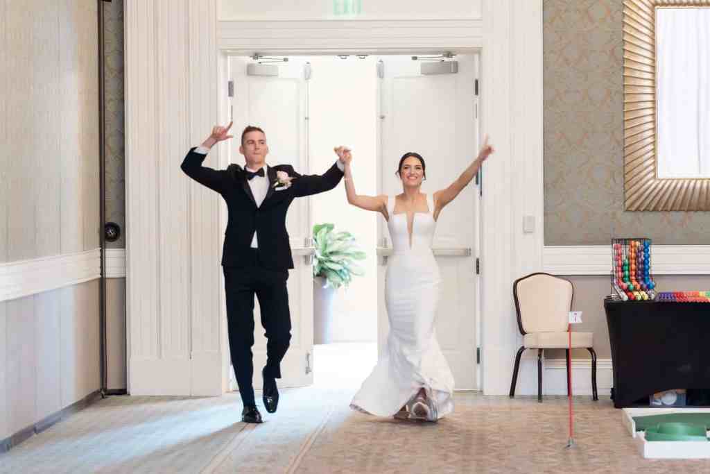 Bride and groom entering their reception