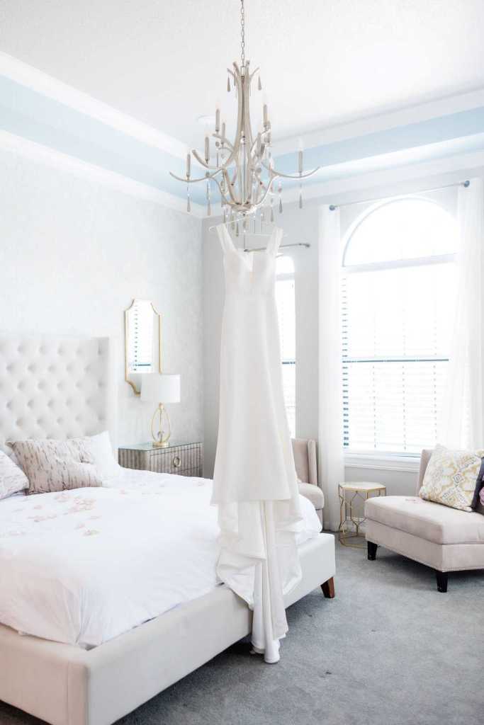 Wedding dress hanging from a chandelier