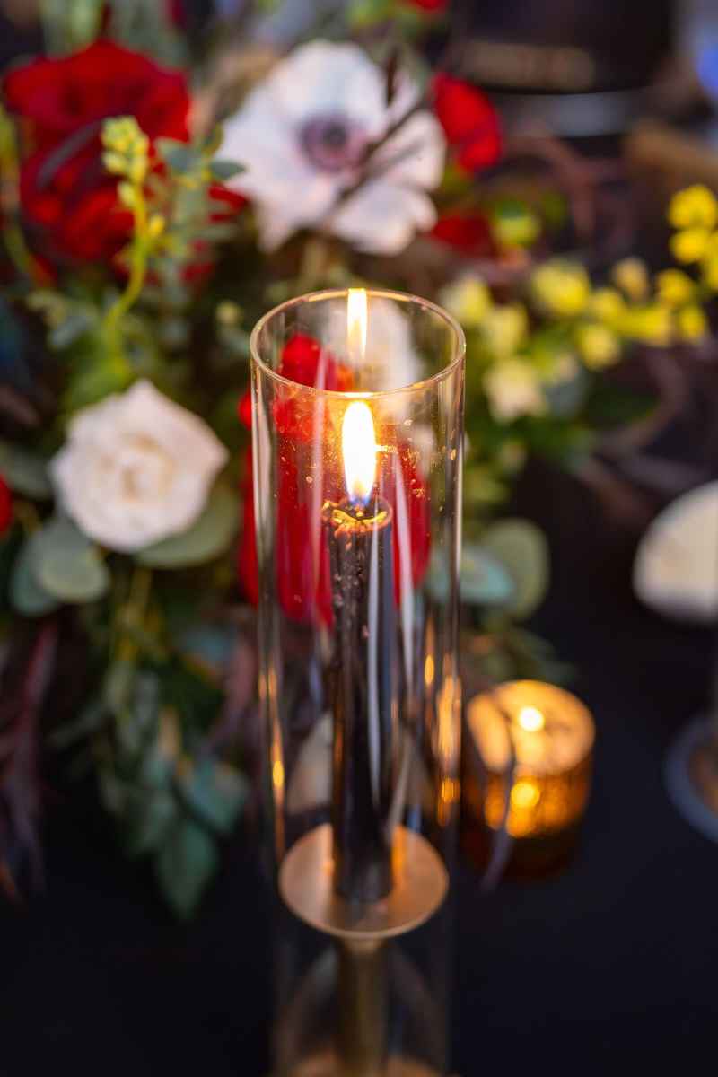 Black taper candle in a hurricane glass