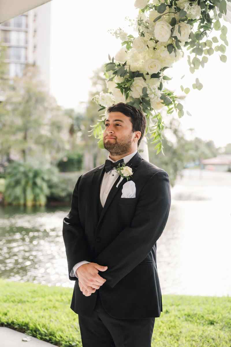Groom watching his bride process up the aisle