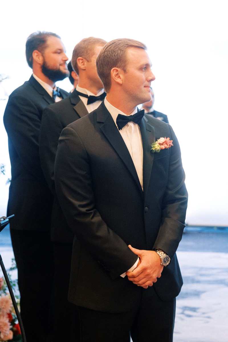Groom watching his bride process up the aisle