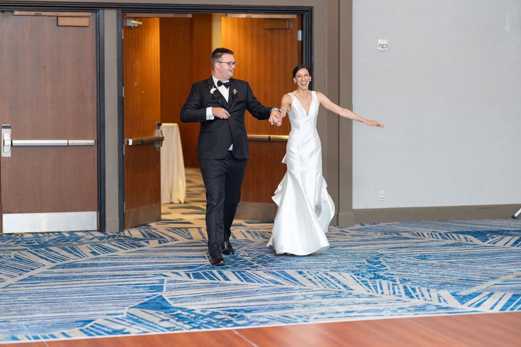Bride and groom entering their reception
