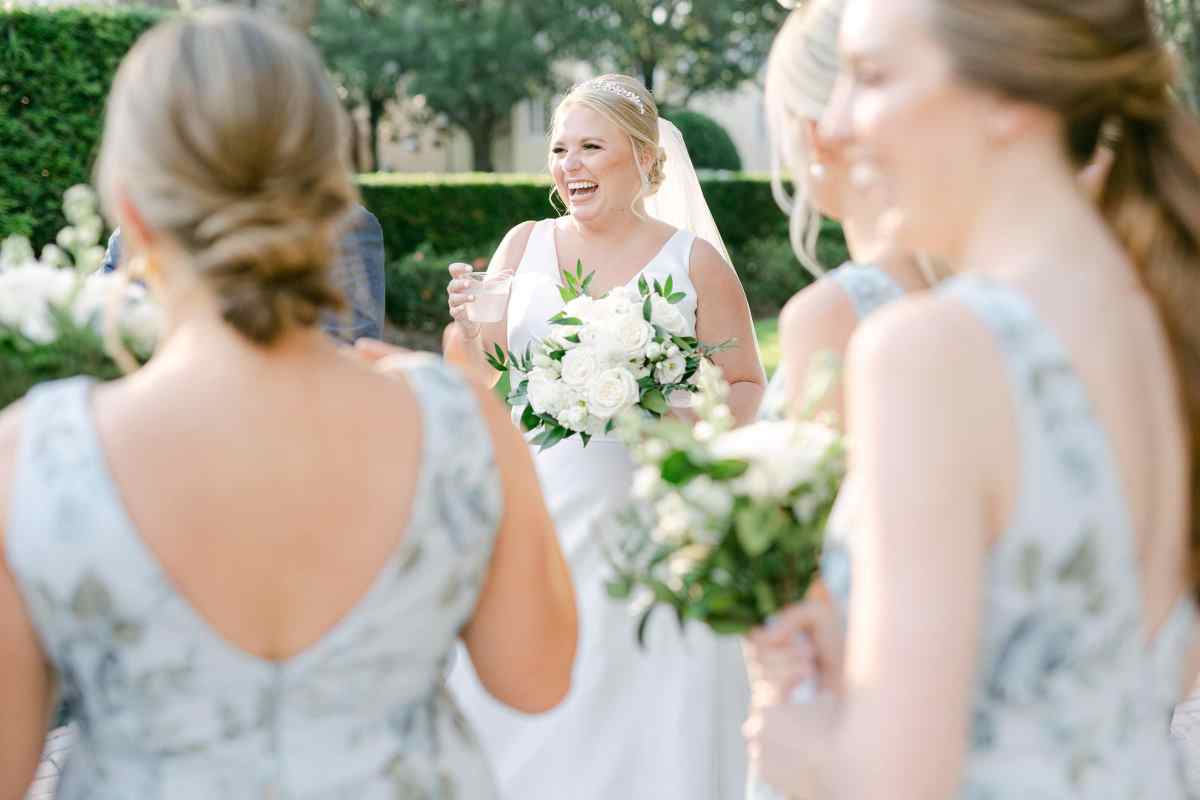 Bride laughing with her wedding party