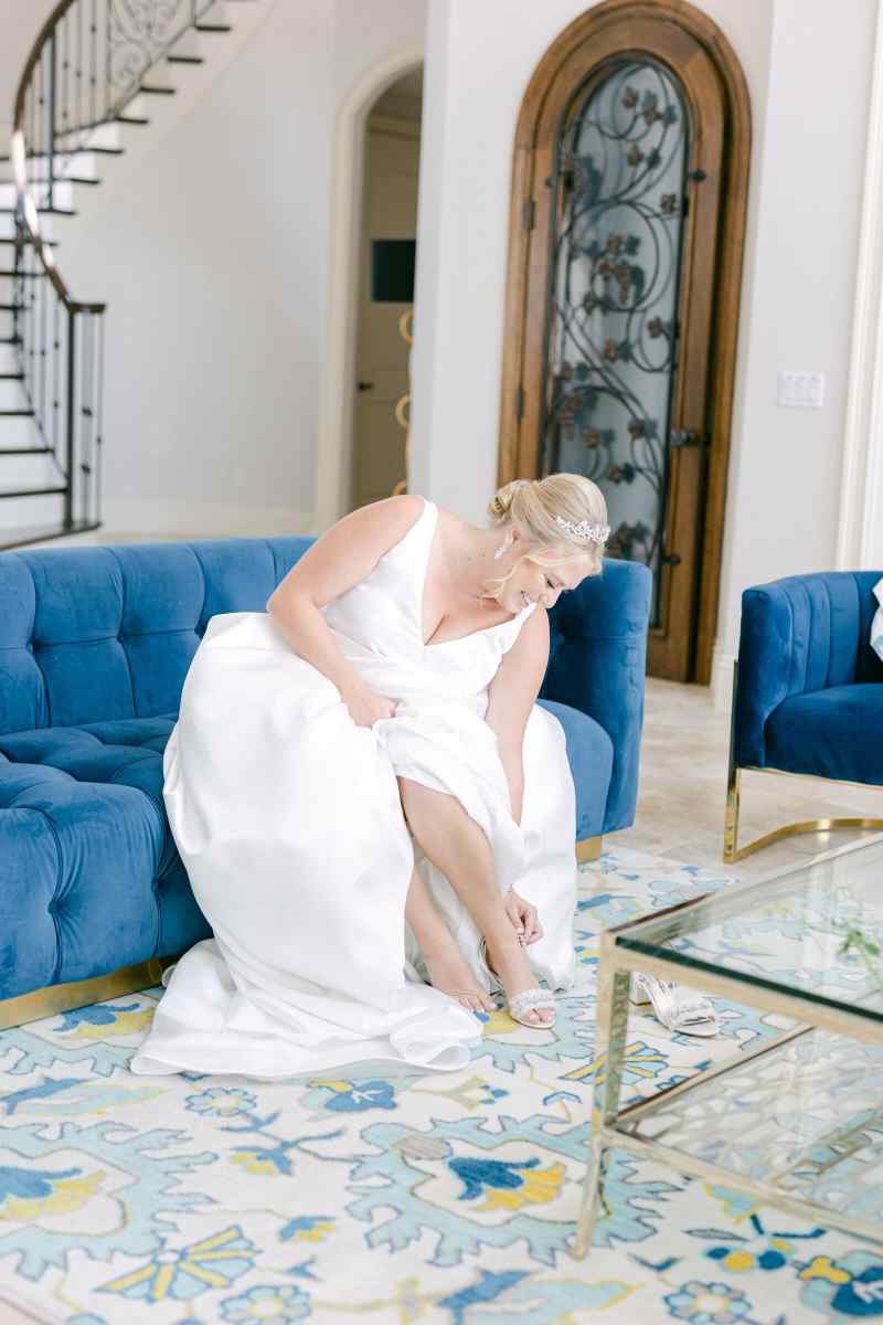 Bride putting on her wedding shoes