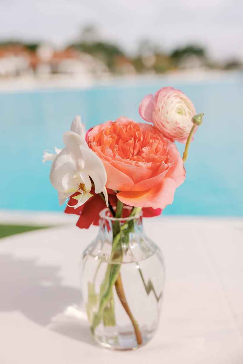 Bud vase with vibrant pink and red floral