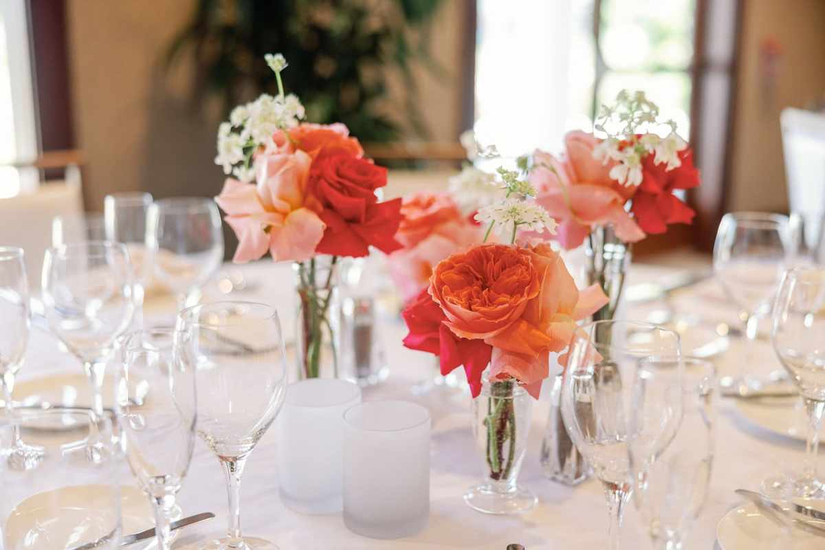 Pink and coral wedding flowers on a reception table