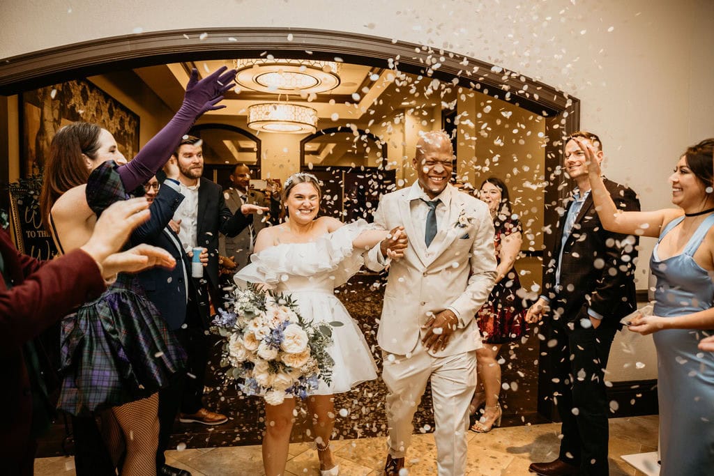 Bride and groom's wedding exit with gold confetti toss