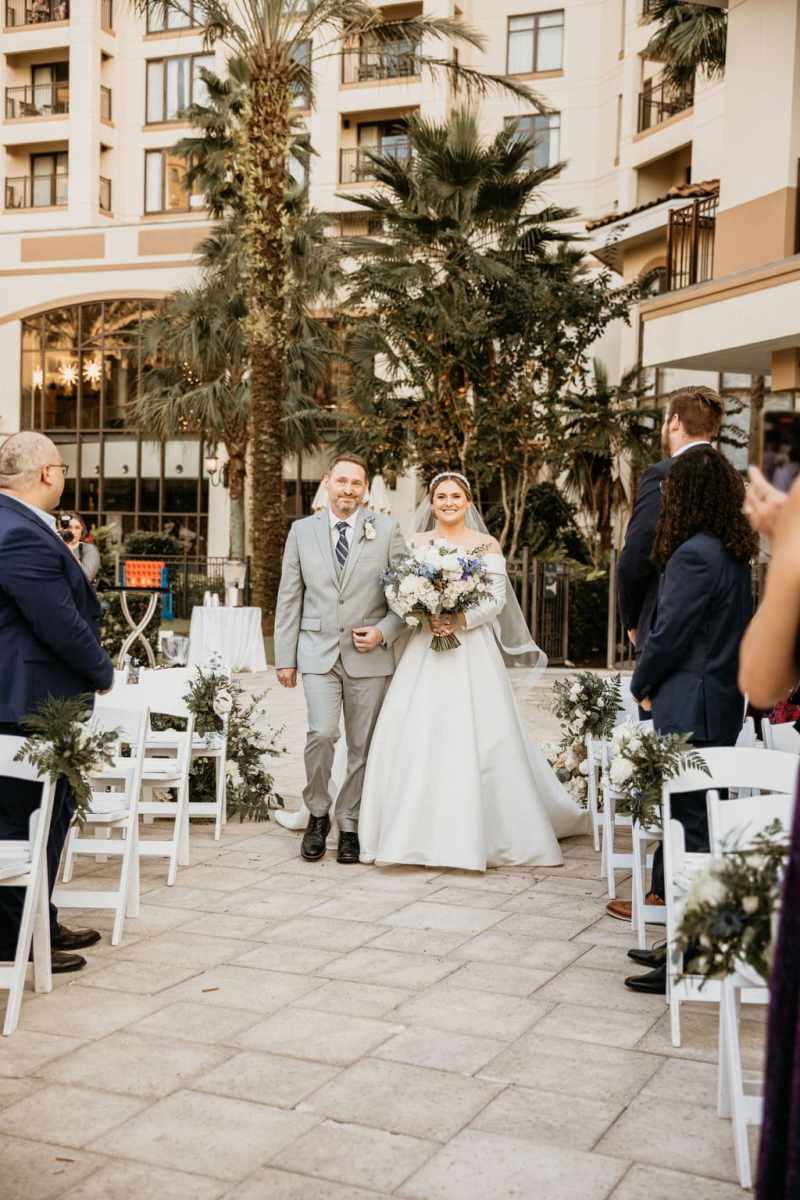 Bride being escorted up the aisle