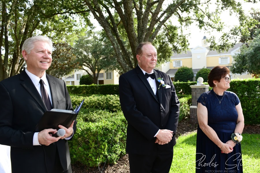Groom watching his bride process up the aisle