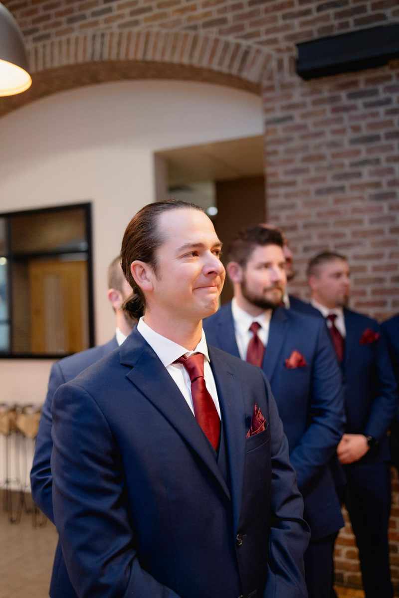 Groom watching his bride process up the aisle