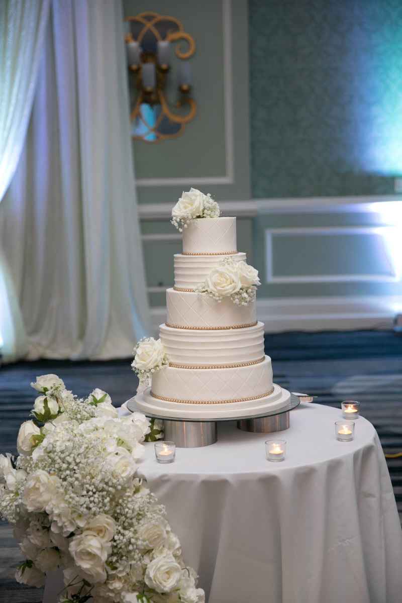 Five-tiered white and gold wedding cake