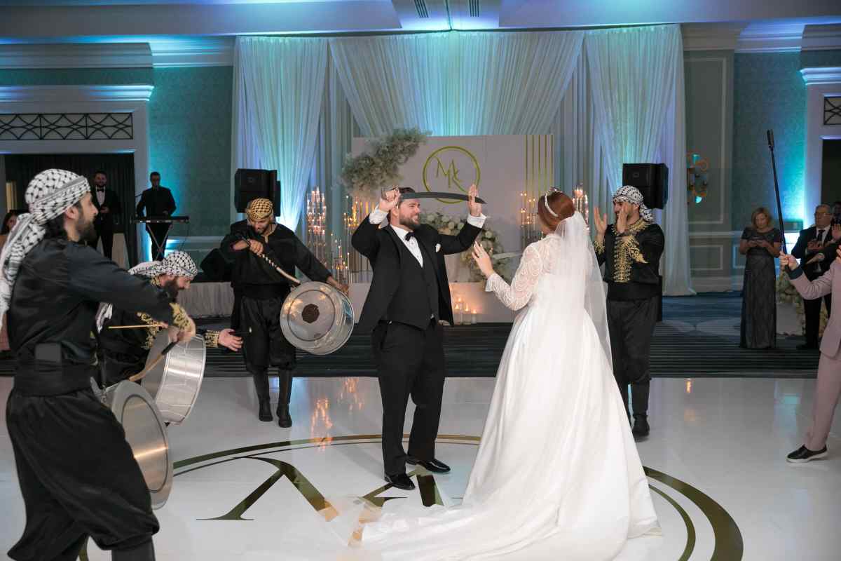 Bride and groom participating in a traditional Middle Eastern dance