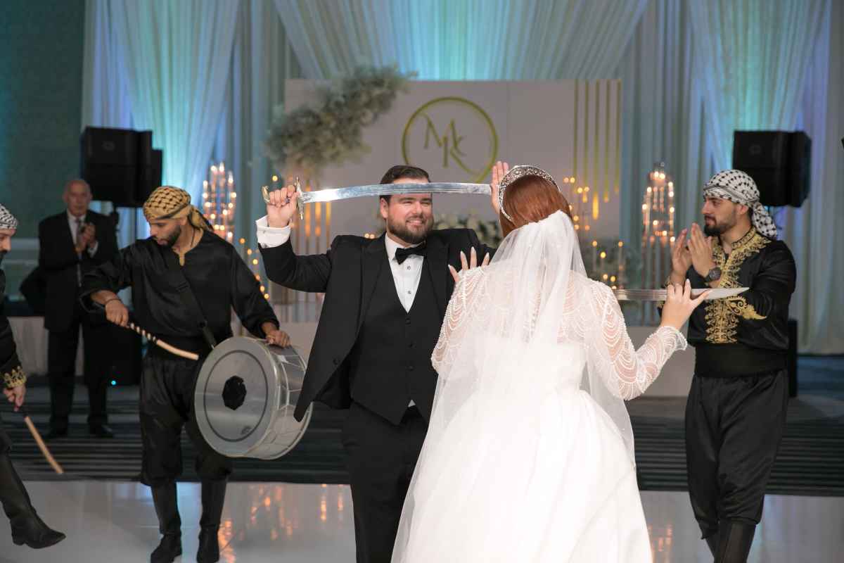 Bride and groom participating in a traditional Middle Eastern dance