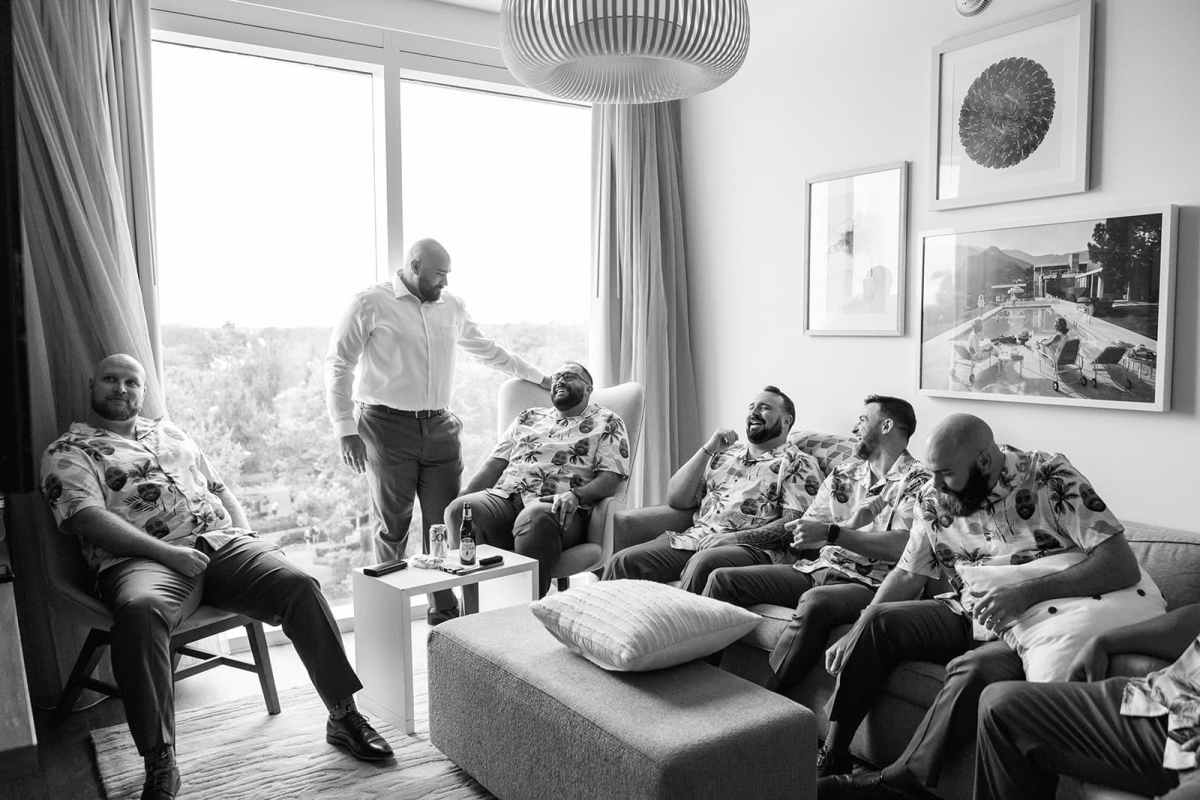 Groom with his groomsmen relaxing before the wedding