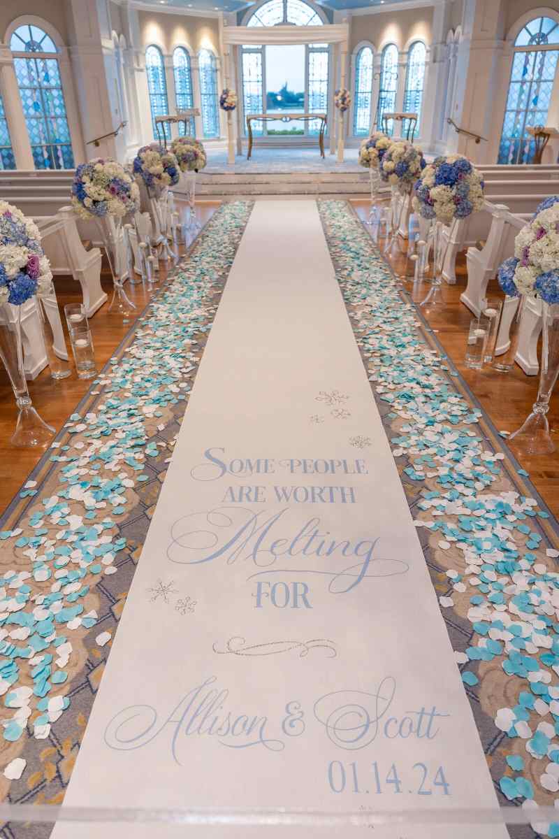 Aisle runner lined with blue and white flower petals
