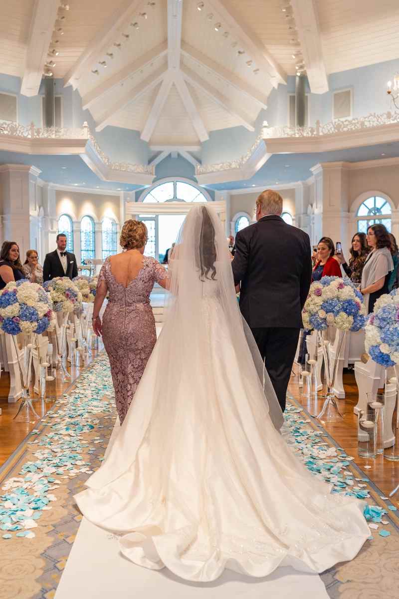 Bride being escorted up the aisle by her parents