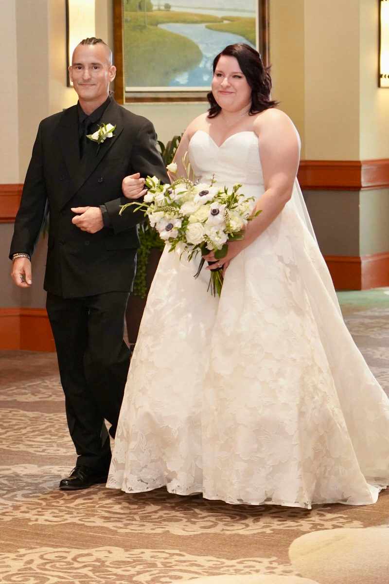 Bride being escorted up the aisle