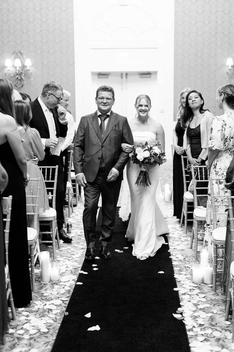 Bride being escorted up the aisle