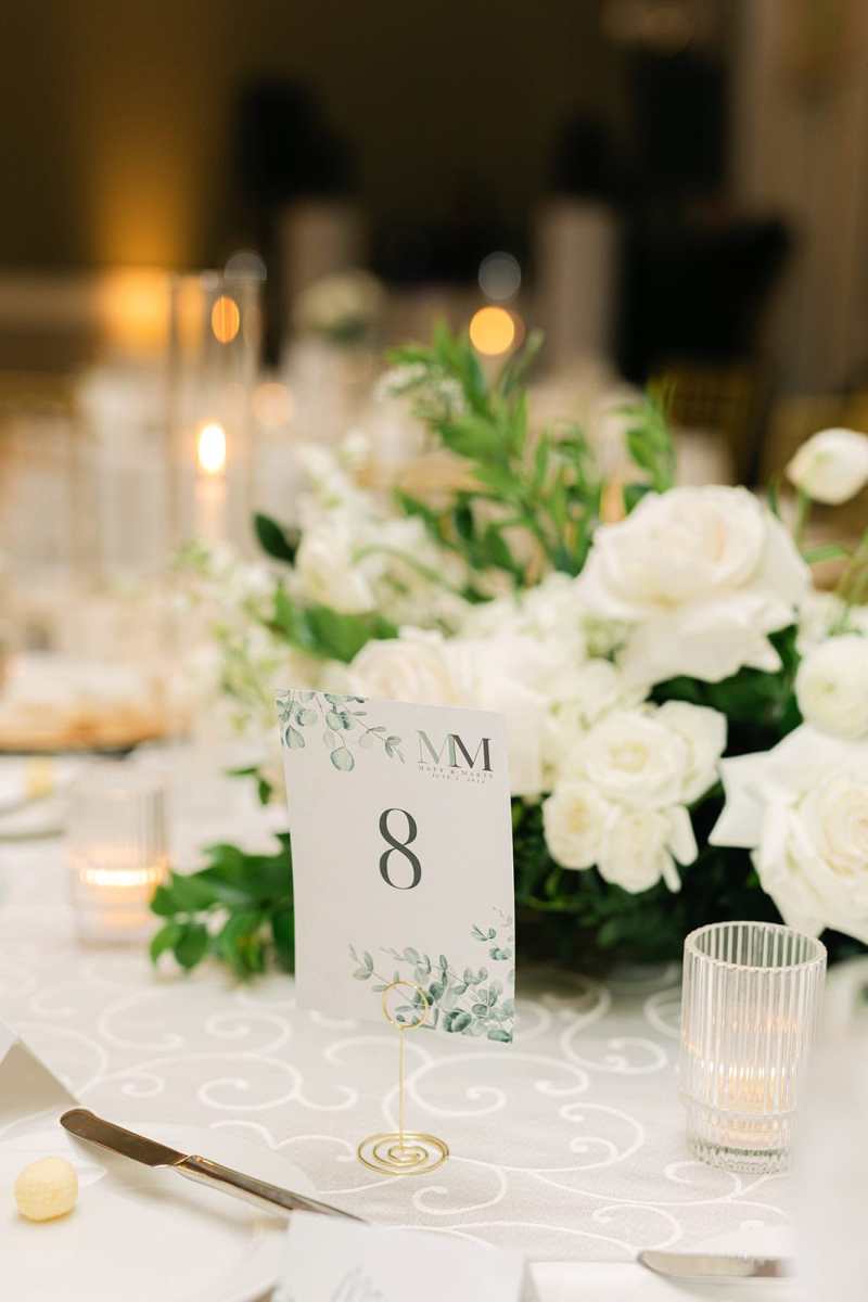 White rose centerpiece with nature themed table numbers