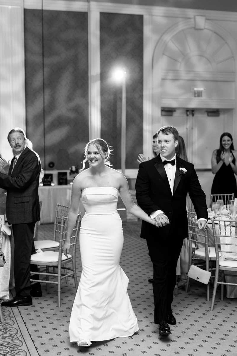 Bride and groom entering their reception