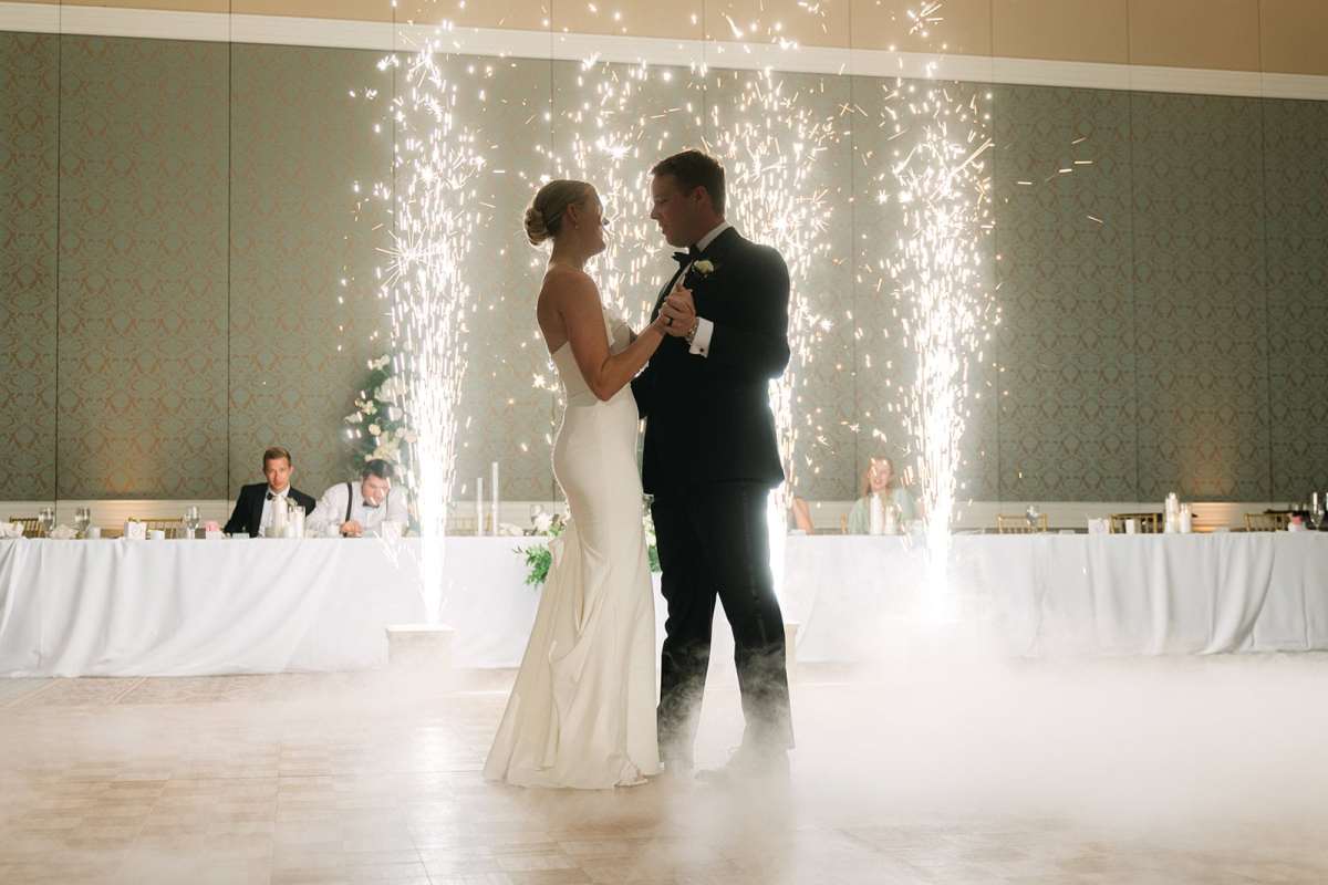 Bride and groom dancing in front of cold sparks