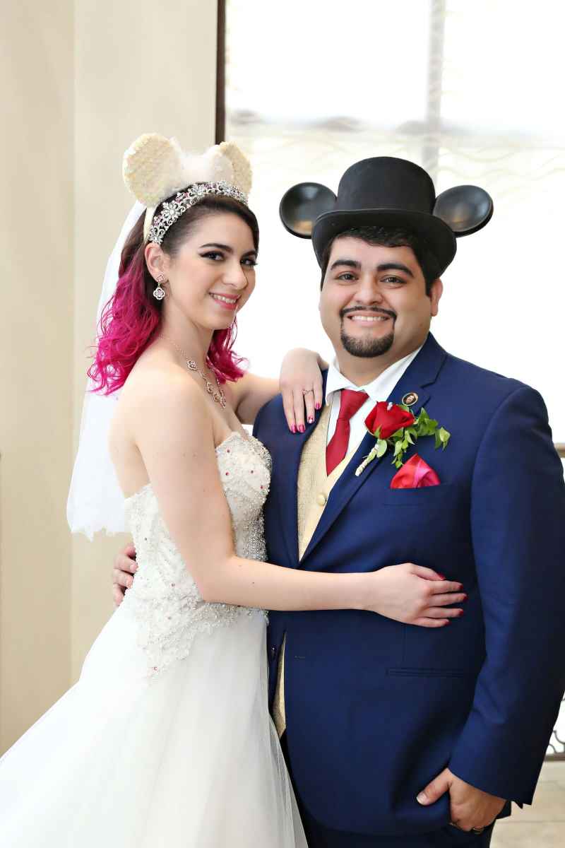 Bride and groom posing with Mickey and Minnie ears