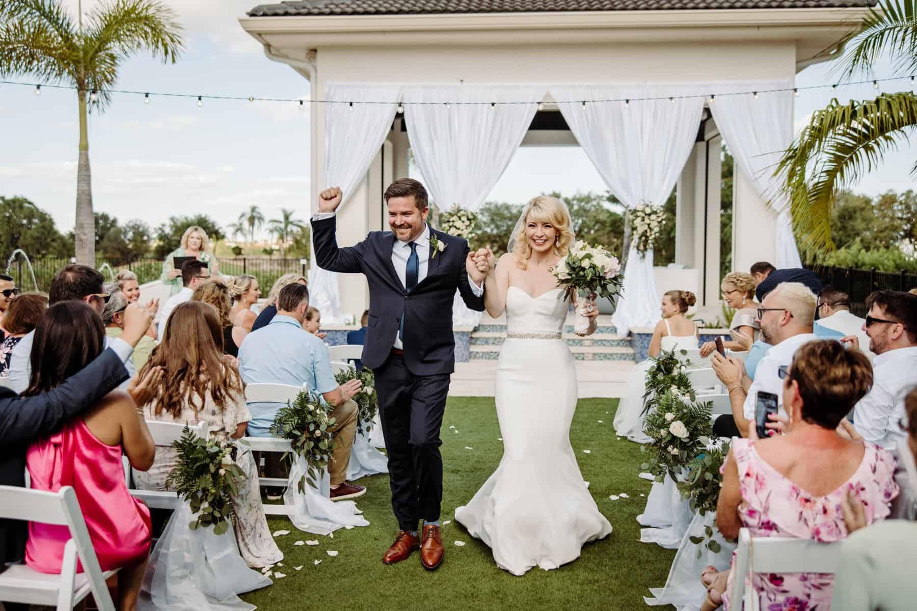 Bride and groom leaving ceremony at waterfront venue in Kissimmee