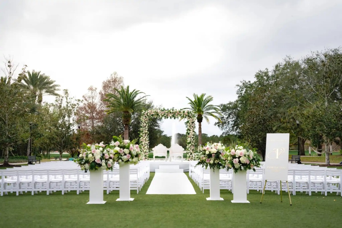 Outdoor luxury wedding ceremony on hotel lawn